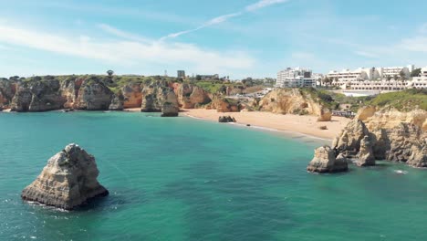 Praia-de-Dona-Ana-beach-with-emerald-sea-water-and-cliffs,-Algarve,-Portugal