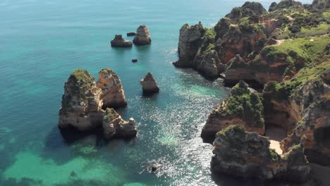 Lagos,-Algarve---Ascending-shot-of-majestic-cliffs-and-turquoise-ocean