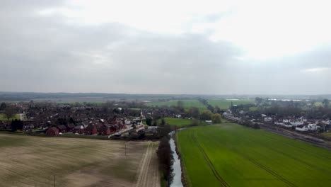 A-stunning-clip-from-above-the-Great-Stour-River-in-England-as-it-cuts-through-a-field-one-side-alive-the-other-baren