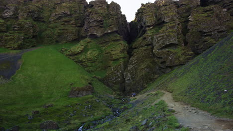 Large-crevasse-in-mountain-in-Snaefellsnes-Peninsula,-Iceland,-wide-shot-tilt-up
