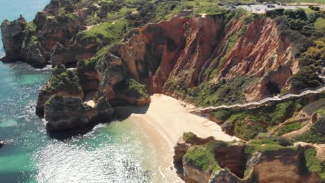 Steep-staircase-going-downhill-accessing-Camilo's-beach,-Lagos,-Algarve-Portugal---Aerial-Wide-panoramic-shot