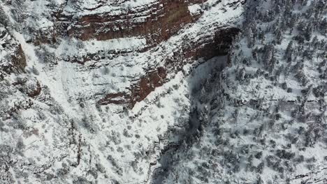 Aerial-View-of-Steep-Snow-Capped-Cliffs-in-Ouray-Ice-Park,-Southwestern-Colorado-USA,-Tilt-Down-Drone-Shot