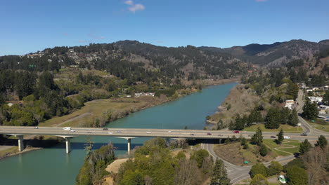 Aerial-flying-forward-shot-of-bridge-over-Chetco-River-in-Brookings,-Oregon