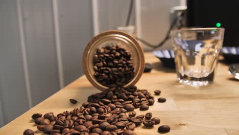 Coffee-beans-on-a-table-top,-slow-motion-dolly-out-establishing-shot
