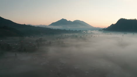 Early-morning-low-lying-fog-blankets-a-farmland-valley
