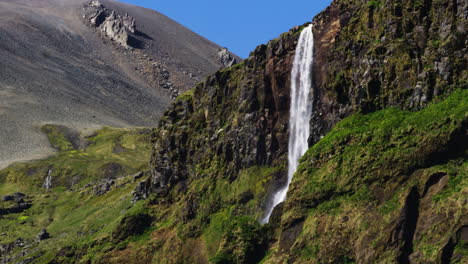 Waterfall-in-the-mountains-of-Snaefellsnes-Peninsula,-Iceland,-wide-shot
