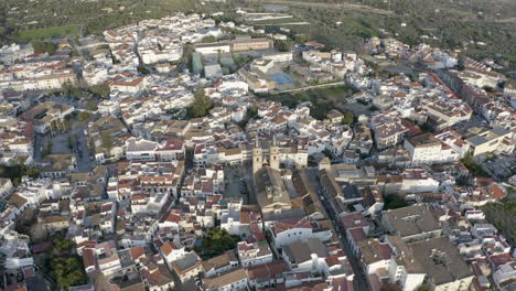 Top-down-view-over-Orgiva-town-in-Spain,-drone-pulling-away-and-rising