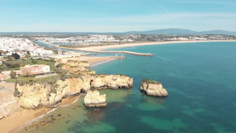 Wide-view-over-Old-Town-Lagos-and-Coastline-near-Praia-do-Estudante,-Algarve,-Portugal---Aerial-Fly-over
