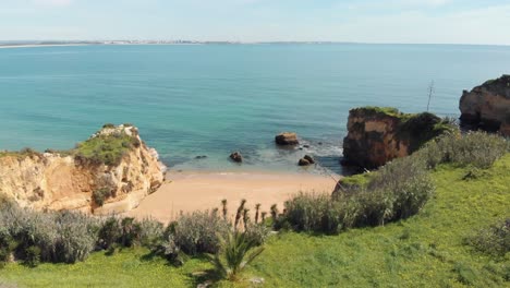 Pristine-turquoise-ocean-shore-bathing-golden-coast-in-Lagos-Algarve,-Portugal---Wide-Panoramic-shot
