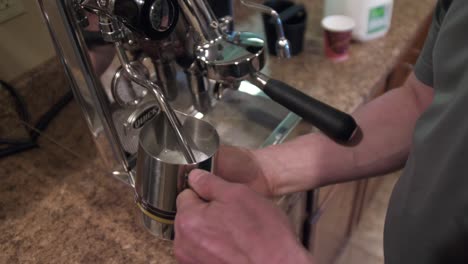 Barista-steaming-milk-in-machine-to-make-coffee,-latte,-cappuccino,-close-up