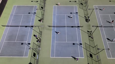 People-playing-on-a-tennis-court,-aerial-static-view,-Los-Angeles