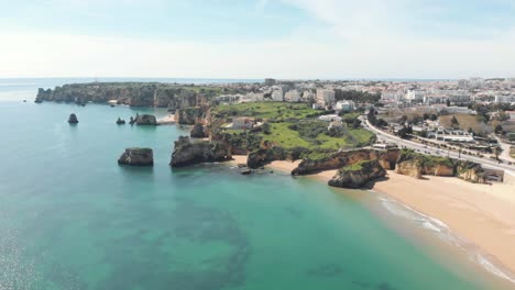 Wide-view-over-Rugged-Coastline-of-Lagos-next-do-Batata-Beach,-Algarve,-Portugal---Aerial-fly-over-wide-shot