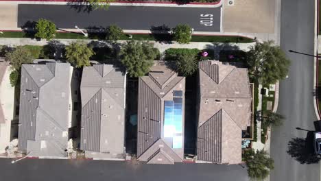 Solar-Panels-on-house,-sun-reflecting,-aerial-rising,-Valencia-California