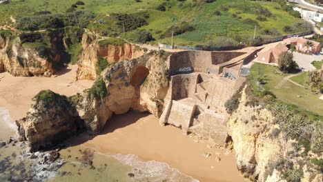 Stone-staircase-in-Pinhão-Beach-within-secluded-scenery-in-Lagos,-Algarve-Portugal---Aerial-Point-of-Interest-Panoramic-shot