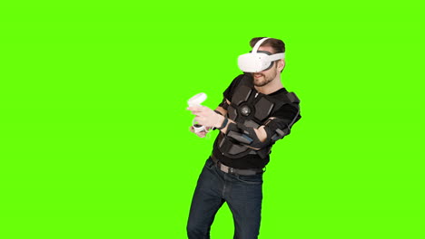 Man-in-white-VR-virtual-reality-oculus-headset-computer-tracking-shooting-aliens-mixed-augmented-immersive-green-screen-aiming-nerdy-gamer-game-futuristic-happy-exciting-future-entertainment-advanced