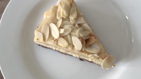 Delicious-Slice-Of-Almond-Cheesecake-In-A-Plate-Rotating