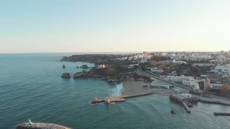 Scenic-sunset-view-over-Fort-of-Ponta-da-Bandeira-next-to-the-river's-estuary,-in-Lagos,-Algarve-Portugal---Aerial-wide-panoramic-shot