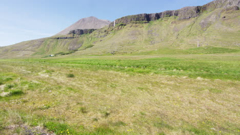 Grassland-and-mountains,-Snaefellsnes-Peninsula,-Iceland,-wide-shot-tilt-up