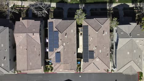 Birds-eye-aerial,-solar-panels-on-house-roofs,-renewable-energy,-Tustin,-California