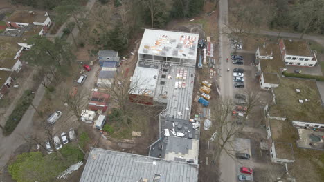 Aerial-of-construction-worker-working-under-large-construction-site