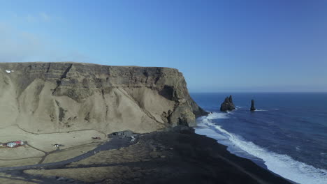 Rugged-Cliffs-With-Reynisdrangar-Basalt-Sea-Stacks-In-Splashing-Sea-Waves-Of-Reynisfjara-Beach-Near-Vik-In-Southern-Iceland