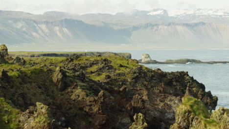 Coastline-and-mountains-in-Snaefellsnes-Peninsula,-Iceland,-wide-shot-tilt-up