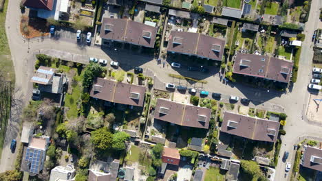 Top-down-aerial-of-suburban-neighborhood-with-green-gardens