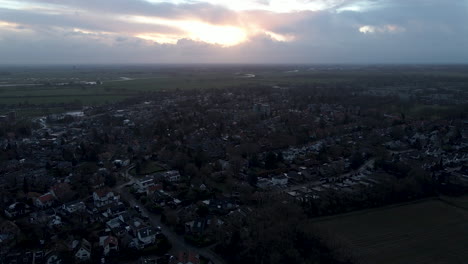 Aerial-of-sun-rising-over-small-idyllic-Dutch-town