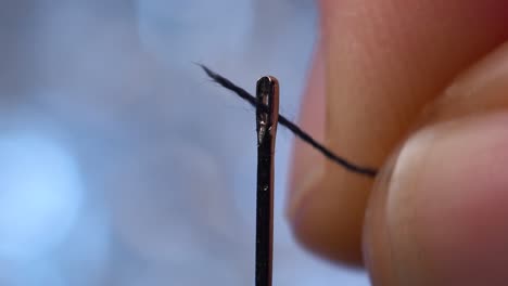 Two-attempts-to-thread-a-needle,-with-the-second-one-successful