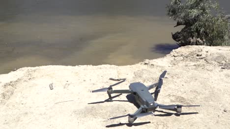 Outdoor-nature-drone-turning-on-and-taking-off-river-edge