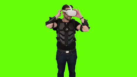 Man-put-on-white-VR-oculus-quest-gaming-headset-gear-virtual-reality-futuristic-immersive-unreal-experience-nerdy-game-gamer-setup-computer-brain-rig-screen-display-augmented-AR-green-impressed-screen