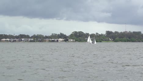 Outdoor-nature-sailing-boats-on-windy-day-on-lake-cloudy-rainy-winter