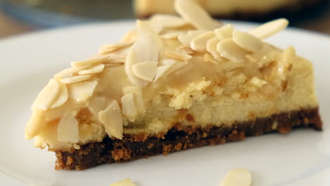Rack-Focus-Of-An-Almond-Cheesecake-Slice-In-A-Plate