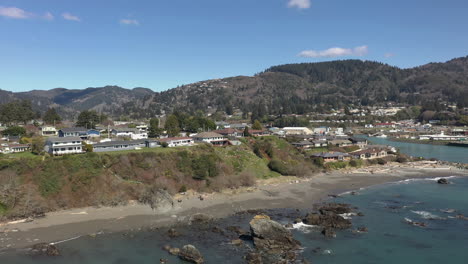 Panorama-Of-Structures-Near-Coastline-With-Forested-Mountains-In-Background-Near-Brookings-Port-Harbor-In-Oregon