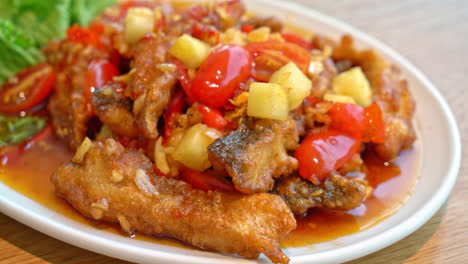 fried-grouper-fish-topped-with-sweet-,sour-and-hot-sauce-on-white-plate---Asian-food-style