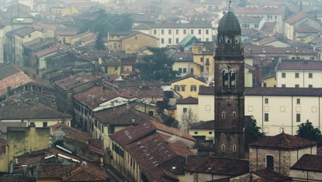 Still-shot-of-tenement-houses-and-a-church-bell-tower-in-Verona