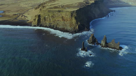 Bird's-Eye-View-Of-Cliffs-And-Reynisdrangar-Rock-Formations-At-Reynisfjara-Black-Sand-Beach-In-Southern-Iceland