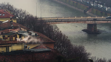 Still-shot-of-Adige-river-and-tenement-houses-during-gloomy-day