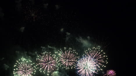 Colorful-fireworks-explode-in-dark-sky.-Low-angle