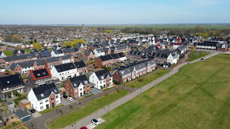 Aerial-reveal-of-houses-in-town-with-solar-panels-on-rooftop