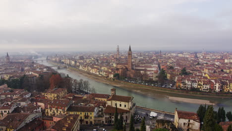 Verona,-Italy-on-a-cloudy-day-seen-from-Castel-San-Pietro,-wide-shot-zoom-out
