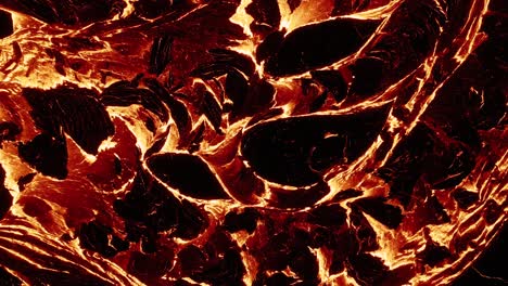 Molten-lava-river-radiating-red-of-extreme-heat,-fluid-magma-stream-on-earth