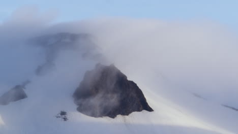 Snow-covered-mountain-in-the-clouds,-Snaefellsnes-Peninsula,-Iceland,-zoom-out