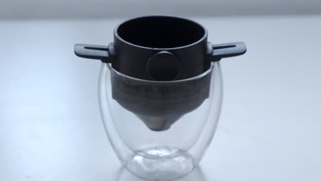 Scooping-Ground-Coffee-Into-Pour-Over-Filter-In-A-Double-Wall-Glass
