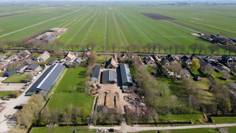 Aerial-of-farms-overlooking-beautiful-green-meadows-in-rural-Holland