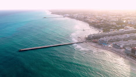 Cinematic-drone-shot-of-pier-and-the-resort-coastline-of-Playa-Del-Carmen-Mexico