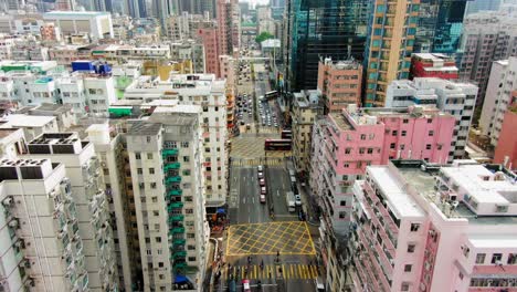 Downtown-Hong-Kong-buildings,-Crosswalk-and-traffic,-High-altitude-aerial-view