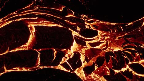 Oozing-river-of-molten-lava-emitting-extreme-heat-at-night,-igneous-magma