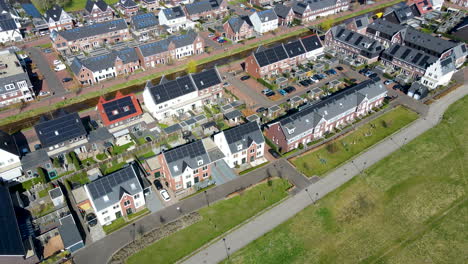 Flying-over-beautiful-suburban-neighborhood-with-solar-panels-on-rooftop
