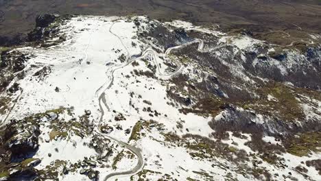 Mountain-road-covered-in-snow-in-winter-drone-shot